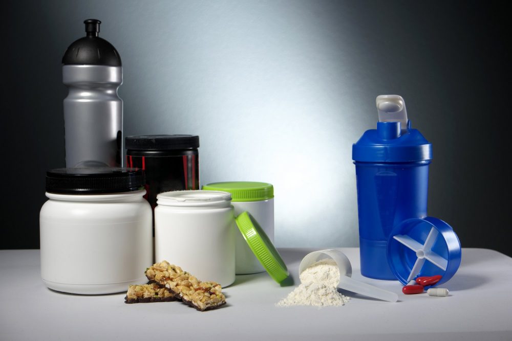 Protein powder bottles with a shake bottle and granola bar